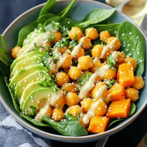 - 2 medium sweet potatoes, peeled and cut into 1-inch cubes - 1 can (15 oz) chickpeas, thoroughly drained and rinsed - 2 tablespoons extra virgin olive oil - 1 teaspoon smoked paprika - 1 teaspoon garlic powder - Sea salt and freshly ground black pepper, to taste - 4 cups fresh spinach or a mix of favorite greens - 1 ripe avocado, sliced into wedges - 1/4 cup tahini - 2 tablespoons freshly squeezed lemon juice - 2 tablespoons water (more as needed for desired dressing consistency) - Toasted sesame seeds, for garnish - Chopped fresh herbs (such as cilantro or parsley), for garnish This Buddha bowl brings together fresh and healthy ingredients. Sweet potatoes and chickpeas offer a satisfying base. The sweet potatoes give a nice sweetness, while chickpeas add protein and fiber. Extra virgin olive oil helps the veggies roast well. Smoked paprika and garlic powder give great flavor. Don’t forget to season with sea salt and black pepper to taste. For greens, I love using fresh spinach. It adds nutrients and a pop of color. The creamy avocado slices on top balance everything. They also add healthy fats. The tahini dressing is a must. It’s smooth and tangy, thanks to lemon juice. Water helps achieve the right dressing consistency. You can add more water if it’s too thick. Lastly, toasted sesame seeds and fresh herbs make the dish beautiful. They add a nice crunch and brightness. This bowl is perfect for lunch or dinner. Enjoy every bite! - Begin by preheating your oven to 400°F (200°C). This step is key for even roasting. - Combine cubed sweet potatoes and rinsed chickpeas in a large bowl. - Add 2 tablespoons of extra virgin olive oil. - Sprinkle in 1 teaspoon of smoked paprika and 1 teaspoon of garlic powder. - Season with sea salt and black pepper to taste. - Toss everything well until the sweet potatoes and chickpeas are coated. - Spread the mixture on a baking sheet lined with parchment paper. - Roast for 25-30 minutes, stirring halfway through. - The sweet potatoes should be tender and slightly caramelized when done. - In a small bowl, whisk together 1/4 cup of tahini, 2 tablespoons of lemon juice, and 2 tablespoons of water. - If the dressing is thick, add more water a teaspoon at a time. - Taste and adjust seasoning with sea salt as needed. - In four serving bowls, place a handful of fresh spinach or mixed greens. - Top each bowl with the roasted sweet potatoes and chickpeas. - Slice a ripe avocado into wedges. - Arrange the avocado slices on top of the roasted mix. - Drizzle the tahini dressing generously over each bowl. - Finish by sprinkling toasted sesame seeds and chopped fresh herbs on top. - Serve immediately while warm for the best taste. Stir the sweet potatoes and chickpeas halfway through roasting. This helps them cook evenly. If you skip this step, some pieces may burn while others stay raw. Roasting takes about 25 to 30 minutes at 400°F (200°C). The result is a crispy, caramelized texture that enhances flavors. To get the right tahini dressing thickness, add water slowly. Start with two tablespoons, then whisk. If it's still too thick, keep adding water one teaspoon at a time. This way, you can control the texture. A smooth dressing coats the bowl well and ties all flavors together. Choose ripe avocados for the best taste. A ripe avocado feels slightly soft when gently squeezed. If it’s hard, it needs more time to ripen. Ripe avocados add creaminess to your bowl, balancing the roasted veggies. This small detail can make a big difference in flavor! {{image_4}} You can add grilled chicken or tofu to boost protein. Chicken gives a nice savory taste. Tofu adds a soft texture that soaks up flavors. Both options make the bowl more filling. For a hearty base, swap sweet potatoes with quinoa or brown rice. Quinoa is a great source of protein and fiber. Brown rice adds a nutty flavor and chewy texture. Both grains complement the other ingredients well. Try using yogurt or a nut-based dressing for a new twist. Yogurt adds creaminess and tang. Nut-based dressings can bring unique flavors, like almond or cashew. These changes keep the dish fresh and exciting. To keep your Sweet Potato Chickpea Buddha Bowl fresh, transfer your leftovers into airtight containers. This will help keep them safe in the fridge for up to three days. Make sure to separate the dressing, so it stays fresh longer. For the best texture, reheat your roasted vegetables in the oven. Set your oven to 350°F (175°C) and place the vegetables on a baking sheet. Heat them for about 10-15 minutes. This will bring back their crispy edges and warm them evenly. You can freeze components like sweet potatoes or chickpeas. Place them in freezer bags or containers. Make sure to label the bags with the date. When you want to use them, thaw the components overnight in the fridge. This helps preserve their taste and texture. Yes, this recipe is fully vegan! It uses sweet potatoes and chickpeas as the main ingredients. The tahini dressing is made without any animal products. This makes it a great choice for anyone following a vegan diet. You can add many toppings to this bowl! Here are some ideas: - Grilled corn for sweetness. - Roasted red peppers for a smoky flavor. - Crumbled feta cheese for a creamy touch (if not vegan). - Sliced radishes for crunch. - Pickled onions for tanginess. Feel free to mix and match what you love! This Buddha bowl is packed with nutrients. Sweet potatoes provide vitamins A and C. Chickpeas offer protein and fiber, helping you feel full. Spinach adds iron and calcium. Avocado gives you healthy fats. This mix makes it a balanced and nourishing meal! The total time for this recipe is 40 minutes. You will spend about 10 minutes on prep. Cooking the sweet potatoes and chickpeas takes around 25-30 minutes in the oven. It’s quick and easy for busy days! You can use canned sweet potatoes, but fresh ones give better texture. If you choose canned, drain and rinse them well. Then, skip the roasting step. Just warm them up in a pan before adding to your bowl. Yes, you can serve this Buddha bowl cold! It makes a great lunch option. Just let the roasted veggies cool down after cooking. Then, mix everything together and enjoy it cold. It tastes delicious either way! This blog post guides you through creating a tasty Buddha bowl. You learned about the key ingredients, easy steps to prepare, and tips for perfecting your meal. With protein options and dressings, you can customize each bowl to your liking. Remember to store leftovers properly for later enjoyment. Enjoy your healthy and fresh dish, packed with flavors and nutrients!