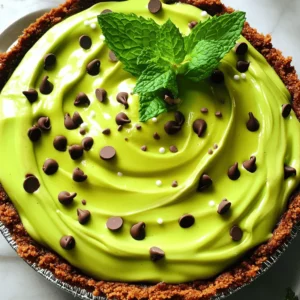 Here is what you need for the Mint Chocolate Grasshopper Pie: - Pre-made chocolate graham cracker pie crust - 1 cup heavy whipping cream - 1/2 cup powdered sugar - 1 teaspoon peppermint extract - 1 cup semi-sweet chocolate chips - 3 tablespoons unsalted butter - 3 tablespoons green food coloring - 1/4 cup mini chocolate chips (for garnish) - Fresh mint leaves (for garnish) These simple ingredients come together to create a delightful dessert. The chocolate crust gives a rich base. The heavy cream adds a light and fluffy texture. The peppermint extract brings a fresh taste. The semi-sweet chocolate chips add depth of flavor. You can adjust the food coloring to get the perfect mint shade. The mini chocolate chips and fresh mint leaves make it look pretty. This pie is not just easy to make; it also tastes amazing! This blog post covered making a delicious Mint Chocolate Grasshopper Pie. We explored ingredients, step-by-step instructions, and helpful tips for perfect results. You can enjoy variations, like gluten-free and vegan options. Lastly, I shared storage info to keep your pie fresh. In conclusion, this pie is a crowd-pleaser. Whether for a party or a quiet night, this dessert shines. Follow these steps, and you’ll impress everyone with your skills!