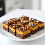 To make this no-bake chocolate peanut butter pumpkin fudge, you will need: - 1 cup pumpkin puree - 1/2 cup creamy peanut butter - 1/2 cup pure maple syrup - 1 cup dark chocolate chips - 1/4 teaspoon pumpkin pie spice - 1/4 teaspoon salt - 1/2 cup crushed graham crackers You can add some extra crunch and flavor with these toppings: - Chopped pecans - Chopped walnuts If you need to swap ingredients, here are some ideas: - Use almond butter instead of peanut butter for a nut-free option. - Swap maple syrup for honey or agave syrup for a different sweetener. - Try using white chocolate chips if you prefer a sweeter fudge. These ingredient choices can help fit different diets and tastes. Feel free to experiment! Start by taking a medium saucepan. Set it over low heat. Add 1 cup of dark chocolate chips and 1/2 cup of creamy peanut butter. Stir this mix with a spatula. Keep stirring until it melts and is smooth. Make sure there are no lumps. This step is key for a rich taste. Once the chocolate and peanut butter mix well, take the saucepan off the heat. Now, mix in 1 cup of pumpkin puree and 1/2 cup of pure maple syrup. Add 1/4 teaspoon of pumpkin pie spice and 1/4 teaspoon of salt. Stir well until everything is blended. You want a nice, even mixture that looks creamy and inviting. Next, grab an 8-inch square baking dish. Line it with parchment paper. Leave some paper hanging over the edges. This will help you lift the fudge out later. Pour the fudge mix into the dish. Use a spatula to spread it evenly. Smooth the top for a nice look. If you like, sprinkle chopped pecans or walnuts on top. Press them lightly into the fudge. Now, place the dish in the fridge. Let it chill for at least 2 hours. You want it to be firm and set. Once ready, lift the fudge out using the parchment paper. Cut it into 16 squares. Enjoy your delicious treat! To get the best texture, use smooth peanut butter. Creamy peanut butter blends well with chocolate. Mix the pumpkin puree in slowly. This keeps the fudge creamy and smooth. Make sure to fold in the crushed graham crackers gently. This adds a nice crunch without overmixing. Serve your fudge on a pretty plate. You can drizzle extra melted chocolate on top. This makes it look fancy! Sprinkle a bit of pumpkin pie spice for flair. For a fun twist, add chopped nuts like pecans or walnuts on top. These toppings enhance the flavor and crunchy texture. One common mistake is rushing the melting process. Always melt chocolate on low heat. High heat can burn the chocolate. Another mistake is not chilling long enough. Make sure to let it set for at least two hours. This helps the fudge firm up. Lastly, don’t skip the salt. It balances the sweetness and boosts flavor. {{image_4}} You can get creative with flavors in your fudge. Adding nutmeg or cinnamon gives it a warm, cozy feel. Just a pinch can brighten up the taste. If you want a stronger spice kick, try mixing in a bit more. You’ll find that small changes can lead to big flavor shifts. Feel free to experiment until you find your favorite blend! If you want to change the sweetness, that’s easy! You can swap pure maple syrup with honey or agave syrup. Each option will add a unique taste to your fudge. If you're looking for sugar-free options, consider using stevia or monk fruit sweetener. These alternatives keep the fudge sweet without extra sugar. Just adjust the amount to suit your taste. Making this fudge vegan is simple! Use almond butter or sunflower seed butter instead of creamy peanut butter. For sweetener, stick with pure maple syrup. Also, check your dark chocolate chips. Some brands are dairy-free. This way, everyone can enjoy this tasty treat! Always read labels to ensure all ingredients match your diet needs. To keep your fudge fresh, place it in an airtight container. Use parchment paper to separate layers if you stack pieces. This helps prevent sticking. Store it in the fridge for best results. This no-bake chocolate peanut butter pumpkin fudge lasts about one week in the fridge. After that, it may lose its great taste and texture. Check for any signs of spoilage before eating. You can freeze the fudge for longer storage. Cut it into squares before freezing. Wrap each square tightly in plastic wrap and place them in a freezer-safe bag. It will keep well for about three months in the freezer. When you're ready to enjoy it, thaw it in the fridge overnight. Yes, you can make this fudge ahead of time. It stays fresh in the fridge for up to one week. Making it in advance gives the flavors time to mix. You can enjoy it on a busy day or share it at a party. Just store the fudge in an airtight container. This keeps it soft and tasty. To cut no-bake fudge easily, chill it well first. Once it is firm, lift it out using the parchment paper. Place it on a cutting board. Use a sharp knife for clean edges. You can warm the knife slightly to help cut through the fudge. Wipe the knife between cuts to keep them neat. If you want extra chocolate flavor, add more chocolate chips. You can mix in 1/4 cup more when melting the chocolate and peanut butter. Another option is to drizzle melted chocolate over the top before it sets. This gives a rich, beautiful finish. You can even try using dark cocoa powder in the mixture for a deeper taste. This blog post covered how to make delicious no-bake fudge. We explored the key ingredients, optional toppings, and even ingredient swaps. I shared step-by-step instructions to melt, mix, and chill your fudge. Plus, I offered handy tips to help you avoid common mistakes. You learned about flavor variations and how to store your fudge properly. In summary, this recipe is easy and fun. It lets you get creative with flavors. You can impress friends and family with tasty treats that are hard to resist. Enjoy making your fudge!