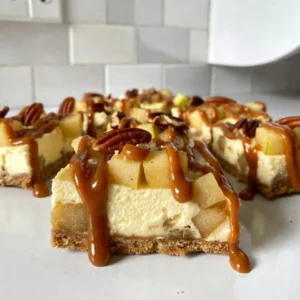 - 1 cup graham cracker crumbs - 1/4 cup granulated sugar - 1/2 cup unsalted butter, melted The crust forms the base of the caramel apple cheesecake bars. I love using graham cracker crumbs for a sweet and crunchy base. The sugar adds a touch of sweetness, while melted butter binds the crumbs together. When mixed, they should feel like wet sand before pressing it into your pan. - 16 oz cream cheese, softened to room temperature - 1/2 cup granulated sugar - 2 large eggs - 1 tsp vanilla extract - 1/2 teaspoon ground cinnamon - 1 medium apple (preferably Granny Smith), peeled and diced into small pieces The cheesecake filling is rich and creamy. Cream cheese is the star ingredient, giving it a smooth texture. Sugar sweetens the mix, while eggs help it set. I always add vanilla extract for flavor and a hint of cinnamon for warmth. Don't forget to fold in diced apples; they add freshness and a nice bite. - 1/2 cup caramel sauce (store-bought or homemade) - 1/4 cup chopped pecans (optional, for added crunch) The caramel topping is what truly elevates these bars. You can use store-bought caramel for ease or make your own for a special touch. The pecans add a delightful crunch, but they're optional. Drizzling caramel over the chilled bars makes each bite a sweet joy. {{ingredient_image_2}} First, set your oven to 325&deg;F (160&deg;C). This temperature helps the cheesecake bake evenly. Line an 8x8 inch baking pan with parchment paper. Allow some paper to hang over the sides. This makes it easy to lift the bars out later. In a medium bowl, mix together: - 1 cup graham cracker crumbs - 1/4 cup granulated sugar - 1/2 cup unsalted butter, melted Stir until it looks like wet sand. Press this mixture into the bottom of the baking pan. Make sure it's even and firm. Place the pan in your preheated oven. Bake for about 10 minutes, until it turns light golden brown. After baking, let it cool while you make the filling. In a large bowl, use an electric mixer to beat together: - 16 oz cream cheese, softened - 1/2 cup granulated sugar Mix these until smooth and creamy, around 2-3 minutes. Then, add in 2 large eggs, one at a time. Mix well after each egg. Add 1 tsp vanilla extract and 1/2 teaspoon ground cinnamon. Now, fold in 1 medium apple, peeled and diced. I prefer Granny Smith apples for a tart bite. Make sure the apple pieces spread evenly in the batter. Gently pour the cheesecake mixture over the cooled crust. Smooth it out with a spatula. Tap the pan on the counter to remove any air bubbles. Return it to the oven and bake for 25-30 minutes. The center should be set but still jiggle slightly. After baking, turn off the oven. Leave the cheesecake inside for about an hour with the door slightly open. This helps prevent cracks. Once cooled, move the pan to the fridge. Chill for at least 3 hours or overnight. When you're ready to serve, take the bars out of the fridge. Drizzle 1/2 cup of caramel sauce over the top. If you like, sprinkle 1/4 cup of chopped pecans on top for extra crunch. Use the parchment paper to lift the cheesecake out of the pan. Cut it into squares. Serve these delicious bars chilled or at room temperature. Enjoy your rich and creamy treat! To get the best texture in your caramel apple cheesecake bars, follow these steps: - Use room temperature cream cheese: This helps create a smooth and creamy filling. Cold cream cheese leads to lumps. - Don&rsquo;t overmix: Mix just until combined. Too much mixing can make the cheesecake dense. - Chill the bars properly: After baking, let them cool before chilling. This helps them set well. If you have dietary needs, here are some easy swaps: - Gluten-free crust: Use gluten-free graham cracker crumbs for the crust. - Dairy-free option: Substitute cream cheese with vegan cream cheese. - Egg replacements: Use flax eggs as a substitute. Mix 1 tablespoon of flaxseed meal with 2.5 tablespoons of water for each egg. A great look adds to the taste! Here&rsquo;s how to present your cheesecake bars: - Serve on a nice platter: Choose a decorative plate for an elegant touch. - Add extra caramel: Place a small bowl of caramel sauce beside the bars for drizzling. - Garnish with apple slices: A few thin apple slices on top can enhance the look. A sprinkle of cinnamon is also nice! Pro Tips Choose the Right Apple: For the best flavor and texture, use tart apples like Granny Smith. They provide a nice contrast to the sweetness of the caramel and cheesecake. Soften Cream Cheese Properly: Make sure your cream cheese is at room temperature before mixing. This ensures a smooth and creamy filling without lumps. Tap to Remove Air Bubbles: After pouring the cheesecake mixture over the crust, lightly tap the pan on the countertop to release any air bubbles, ensuring a perfect texture. Chill Overnight for Best Results: While 3 hours of chilling is sufficient, letting the bars sit overnight in the fridge enhances their flavor and texture, making them even more delightful. {{image_4}} You can easily make these caramel apple cheesecake bars nut-free. Simply skip the pecans in the topping. This keeps them safe for those with nut allergies. If you want extra crunch, try using seeds instead. Sunflower seeds or pumpkin seeds work well. They add a nice texture without the nut risk. To make these bars gluten-free, swap out the graham cracker crumbs. Use gluten-free graham crackers or almond flour as a base for the crust. Make sure to check all other ingredients for gluten. This way, everyone can enjoy these delicious bars without worry. You can boost the flavor of these bars in fun ways. Try adding a pinch of nutmeg along with the cinnamon for more warmth. You could also mix in some caramel bits into the filling. This adds little pockets of gooey caramel. If you love spice, consider adding a touch of ginger or cardamom. These flavors pair well with apple and caramel. Store your caramel apple cheesecake bars in an airtight container. This keeps them fresh and moist. Place parchment paper between layers to prevent sticking. Always let them cool completely before storing. This helps avoid soggy bars. You can keep these cheesecake bars in the fridge for up to five days. Make sure to cover them well. They taste great cold or at room temperature. If you notice any change in smell or texture, it&rsquo;s best to toss them. You can freeze these cheesecake bars for up to three months. Cut them into squares before freezing. Wrap each piece tightly in plastic wrap, then place them in a freezer bag. Thaw them in the fridge when you're ready to enjoy. This way, you&rsquo;ll have a tasty treat ready anytime! Yes, you can! While I love Granny Smith apples for their tartness, you can choose any apple you like. Honeycrisp, Golden Delicious, or Fuji apples work well too. Each type gives a unique flavor to the bars. Just make sure to peel and dice them into small pieces. Making homemade caramel sauce is easy! Here&rsquo;s a simple method: - In a saucepan, combine 1 cup of granulated sugar and 1/4 cup of water. - Heat over medium heat until the sugar dissolves. - Let it boil without stirring until it turns a deep amber color. - Remove from heat and carefully add 1/2 cup of heavy cream. Be cautious, as it will bubble up. - Stir until smooth and add a pinch of salt for flavor. Let it cool before drizzling over your cheesecake bars for a rich taste. Absolutely! You can make these bars a day or two ahead. After baking and chilling, cover them well and store them in the fridge. This makes them perfect for parties or potlucks. Just drizzle the caramel on top right before serving for the best flavor. This blog post covered how to make tasty cheesecake bars. We looked at key ingredients for the crust, filling, and caramel topping. Then, we followed easy steps to bake and chill these delicious bars. I shared tips for perfect texture and variations for dietary needs. You also learned the best ways to store and serve them. Enjoying these treats is simple and fun. You can customize them to fit your tastes. Now it's time to get cooking!